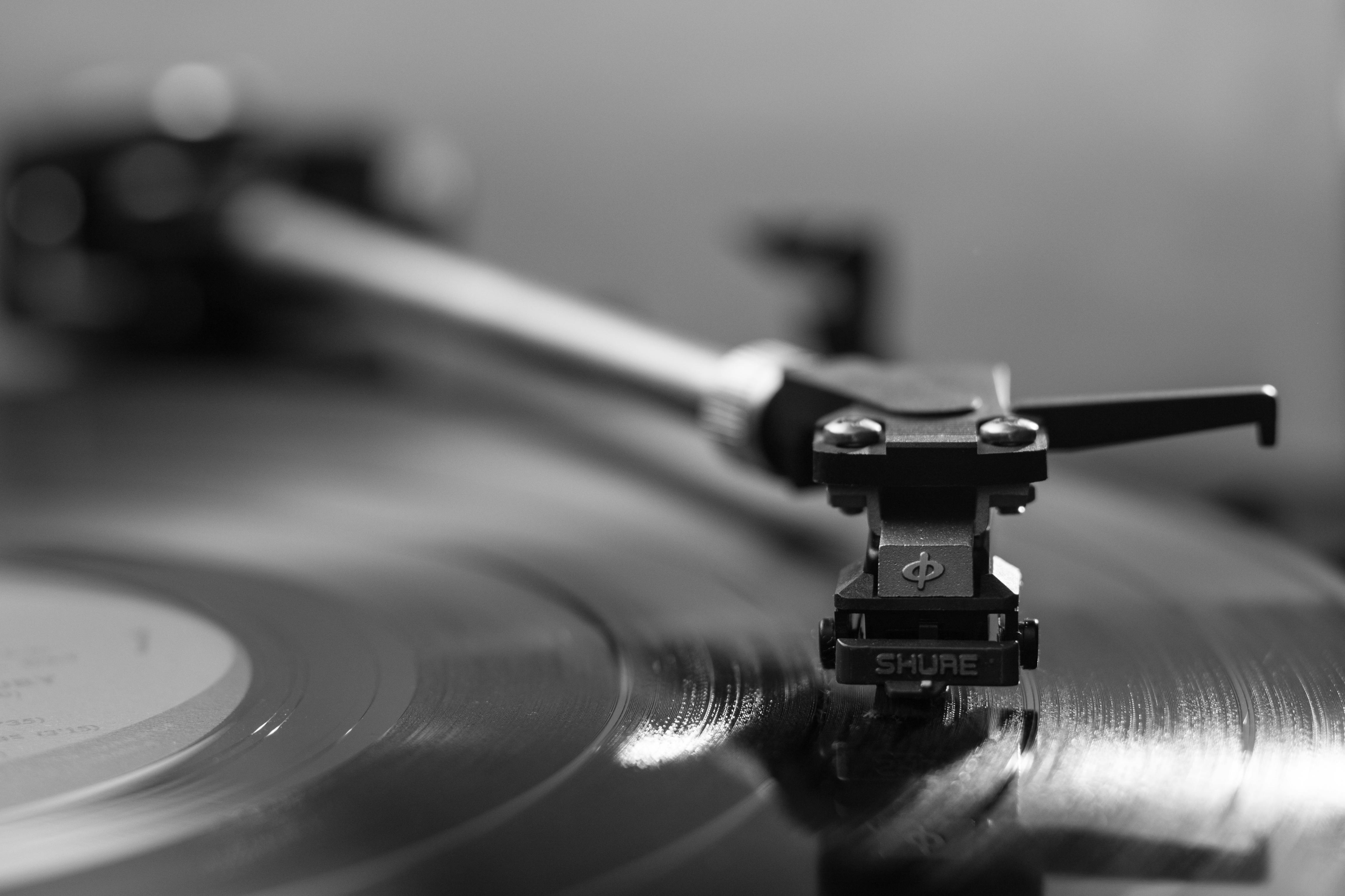 Close-up of a vinyl record spinning on a Nashville turntable, capturing the needle’s precision in striking black and white.