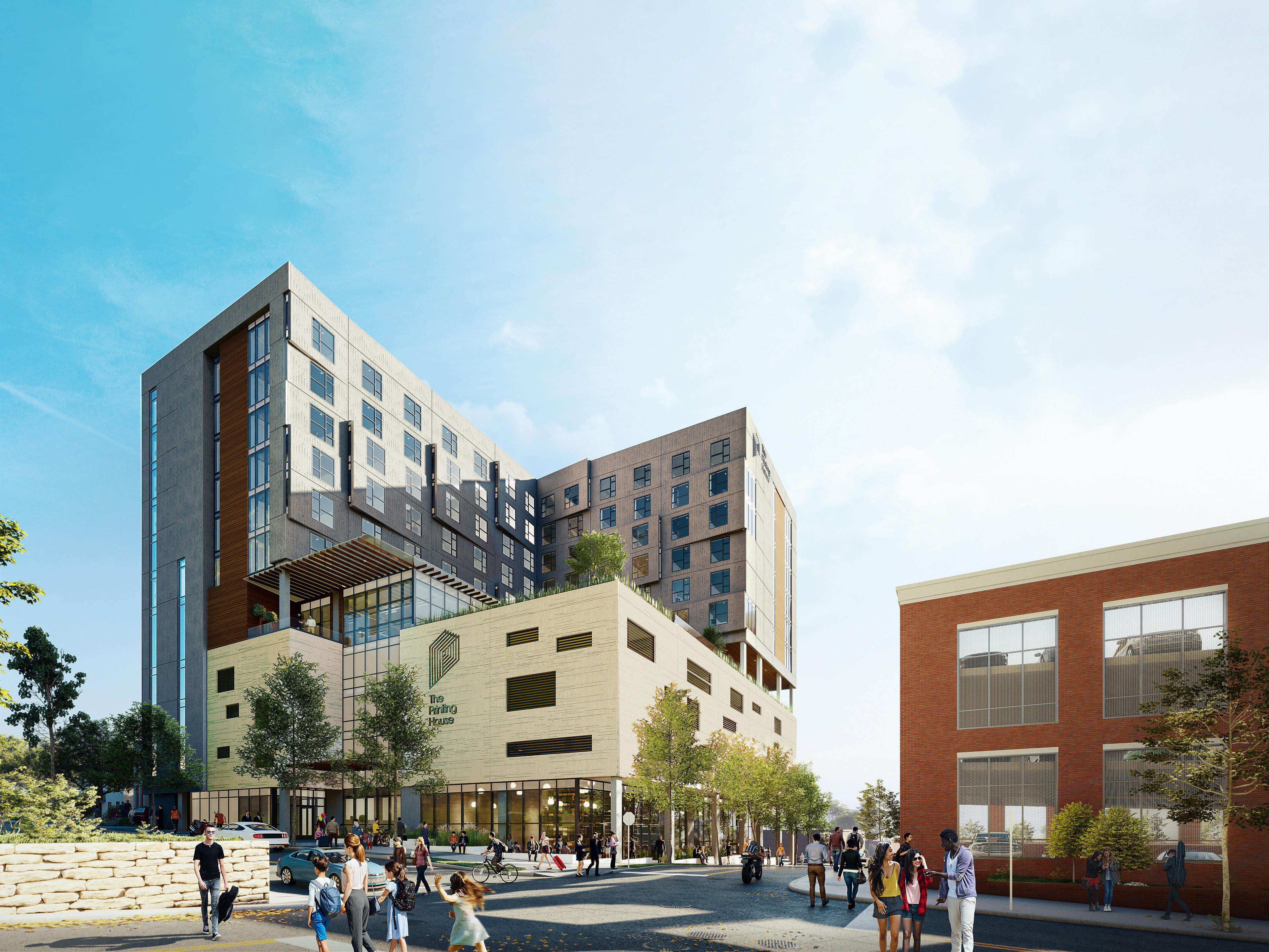 A modern multi-story building with a unique architectural design stands beside a red brick structure in the heart of Nashville. People stroll along the street, and trees are scattered around the area, adding a touch of greenery to this vibrant cityscape.