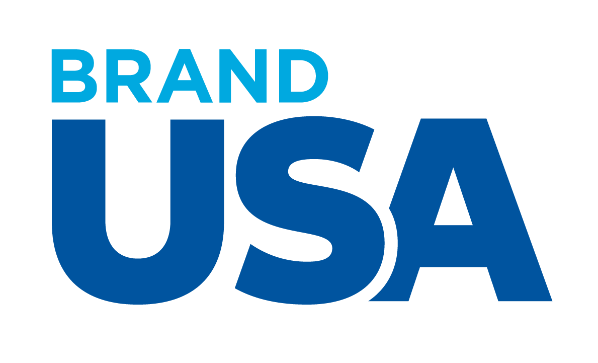 The words "BRAND USA" in bold blue letters with "BRAND" in light blue above "USA" in dark blue on a transparent background.