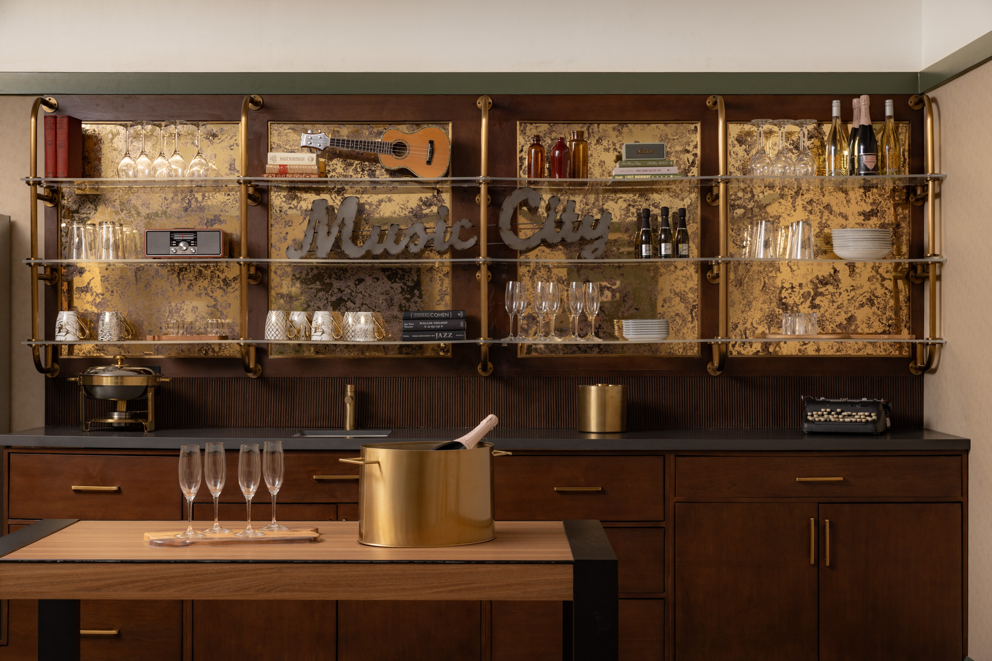 Hotel mini bar setup in a contemporary hotel room with beverages and glasses neatly arranged in the mini bar at The Printing House